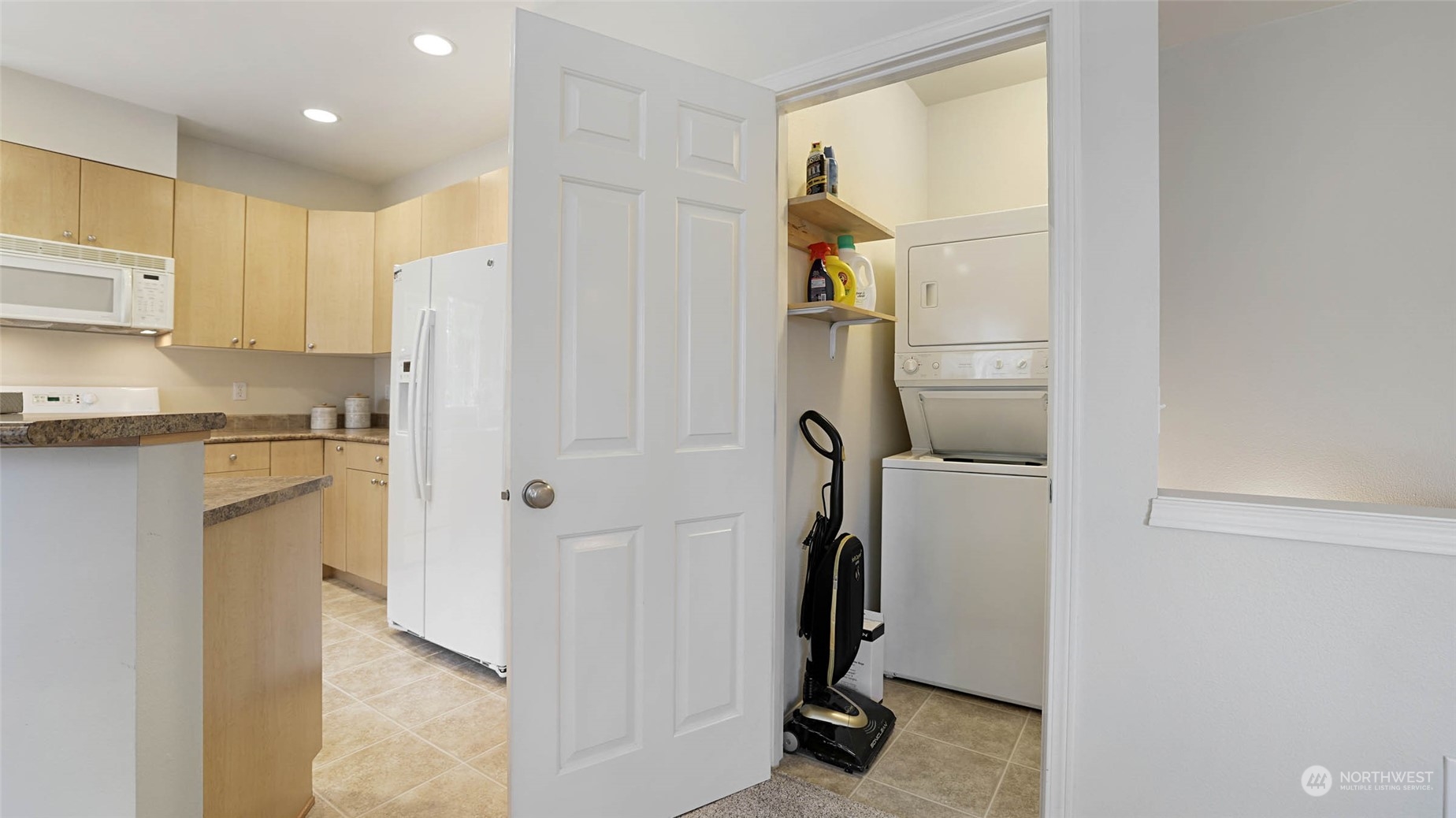 217 South 49th Street, Unit B Renton, WA 98055 - Photo 12 of 16 a view of a kitchen with a sink and refrigerator