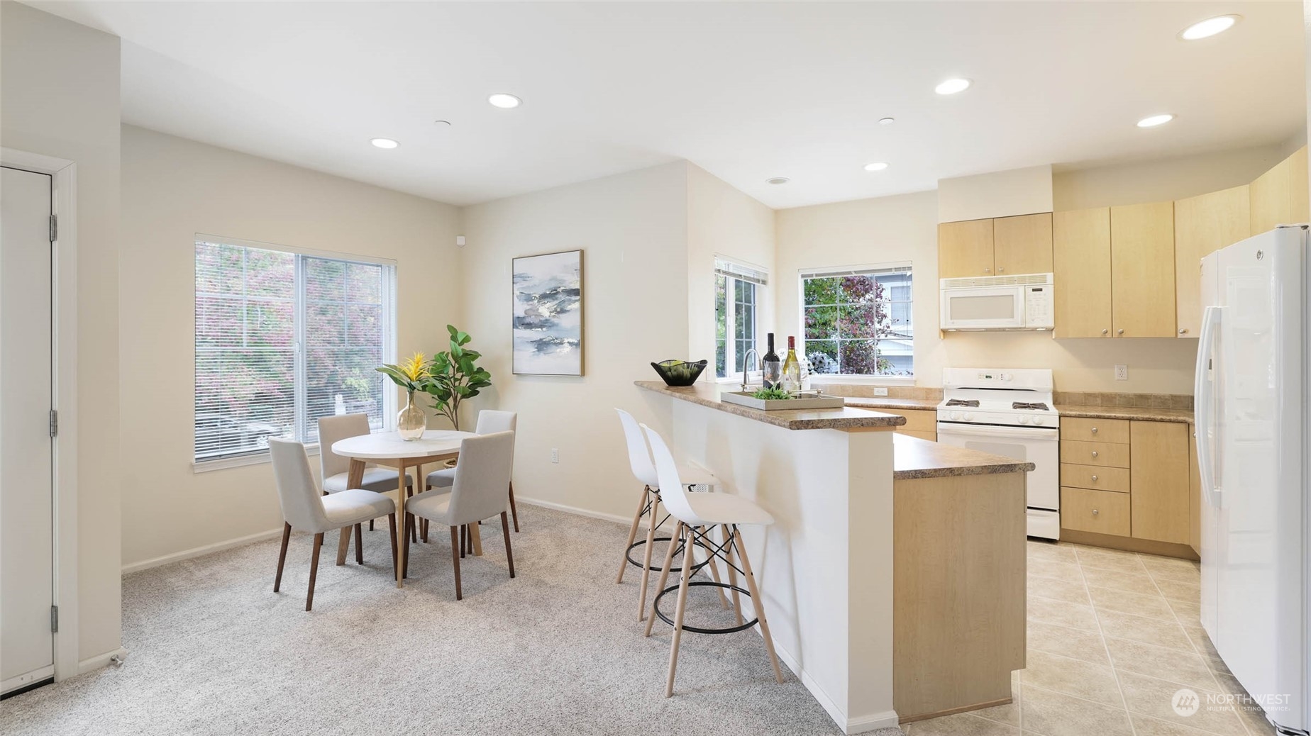 217 South 49th Street, Unit B Renton, WA 98055 - Photo 4 of 16 a kitchen with white cabinets and refrigerator