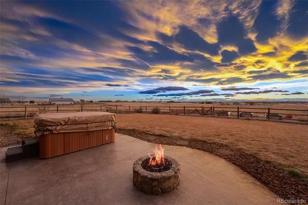 a view of a dining hall with wooden floor and a sink
