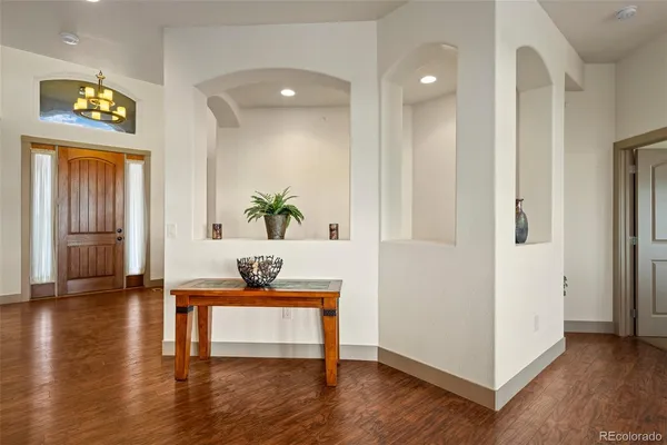 a living room with furniture large window and a fireplace