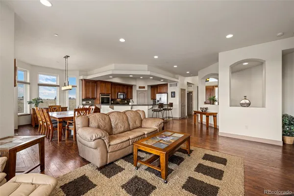 a living room with furniture a large window and a fireplace