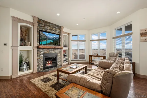 a living room with furniture a fireplace with wooden floor