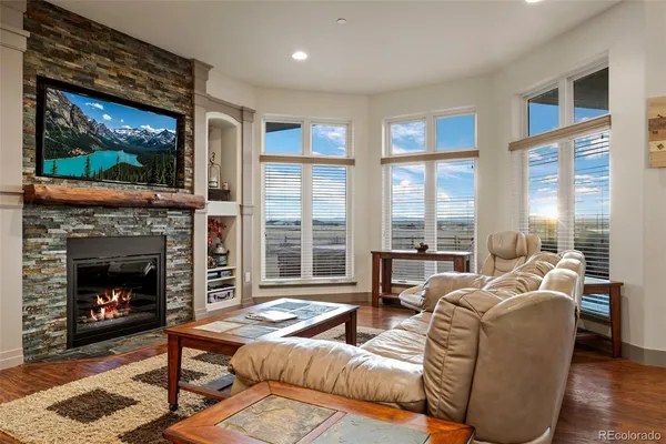 a living room with furniture a window and a fireplace