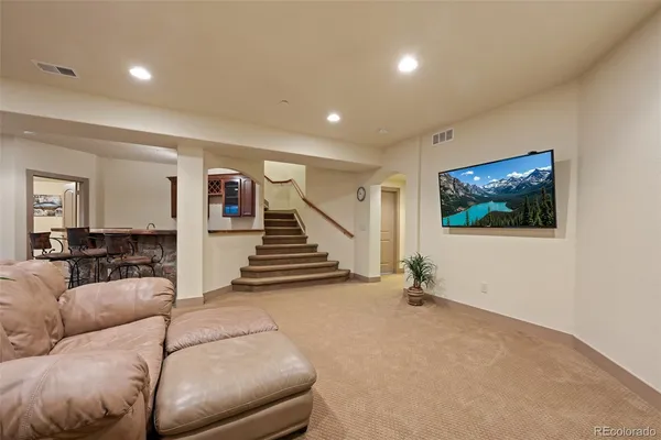 a living room with furniture and stairs