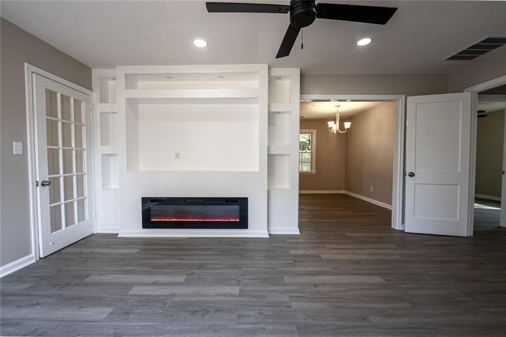 3122 Semmes Street Atlanta, GA 30344 - Photo 11 of 33 a view of an empty room with wooden floor a fireplace and a window