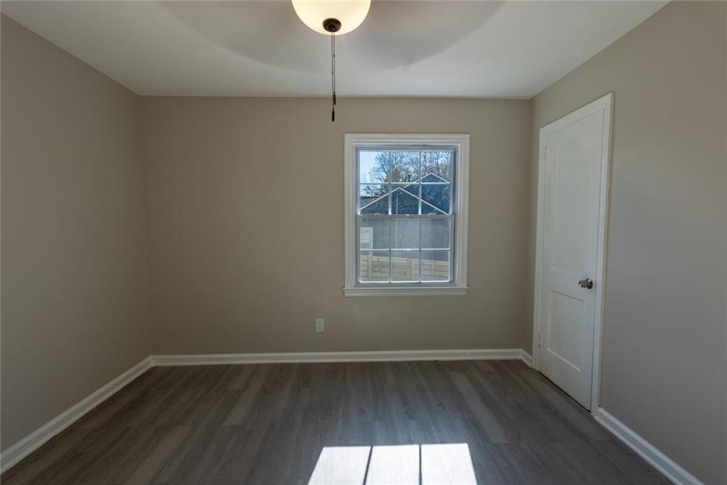 3122 Semmes Street Atlanta, GA 30344 - Photo 18 of 33 an empty room with wooden floor and windows