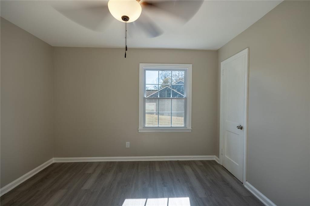 3122 Semmes Street Atlanta, GA 30344 - Photo 20 of 33 an empty room with wooden floor and windows