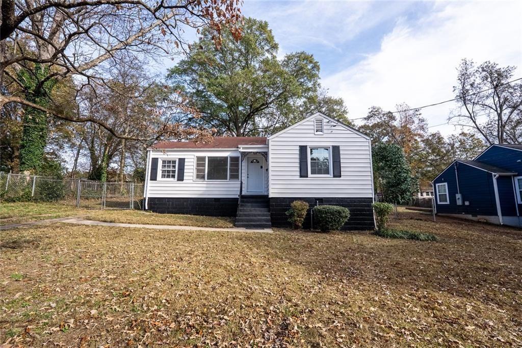 3122 Semmes Street Atlanta, GA 30344 - Photo 4 of 33 a front view of a house with a yard