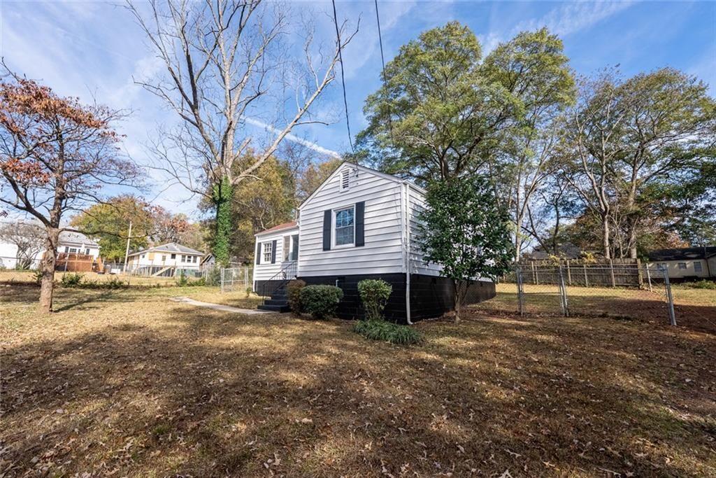 3122 Semmes Street Atlanta, GA 30344 - Photo 6 of 33 a front view of a house with a yard and trees