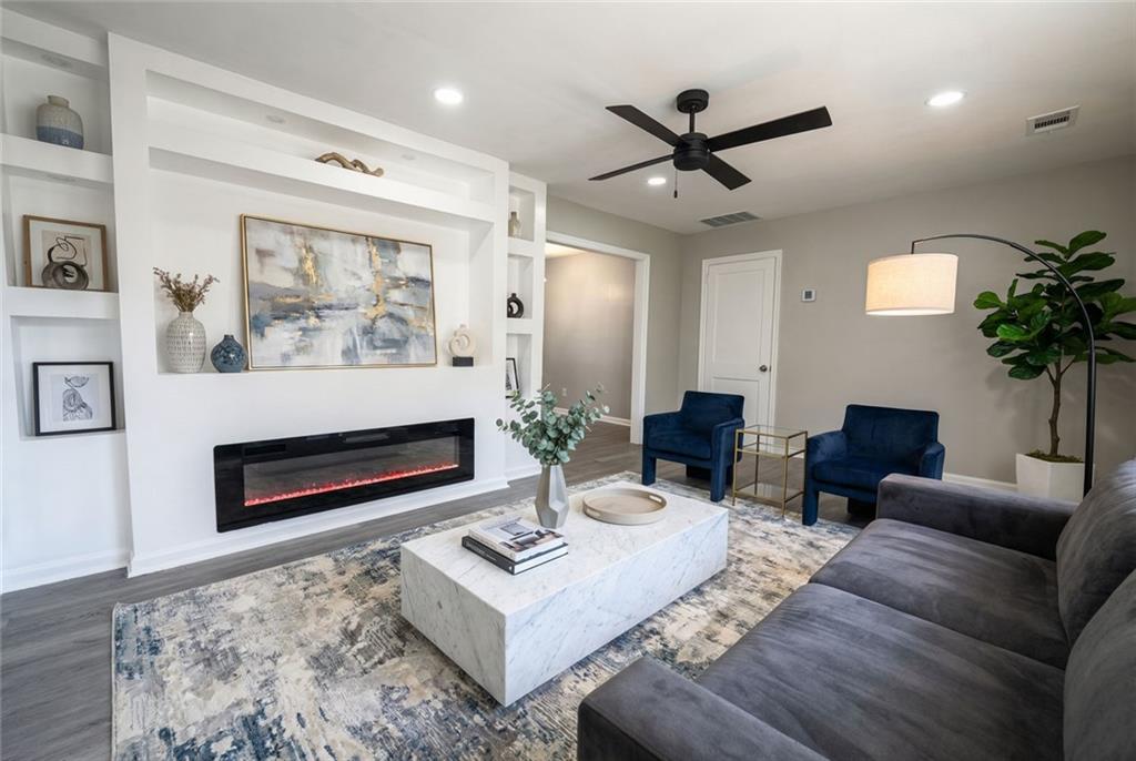 3122 Semmes Street Atlanta, GA 30344 - Photo 8 of 33 a living room with furniture a chandelier and a fireplace