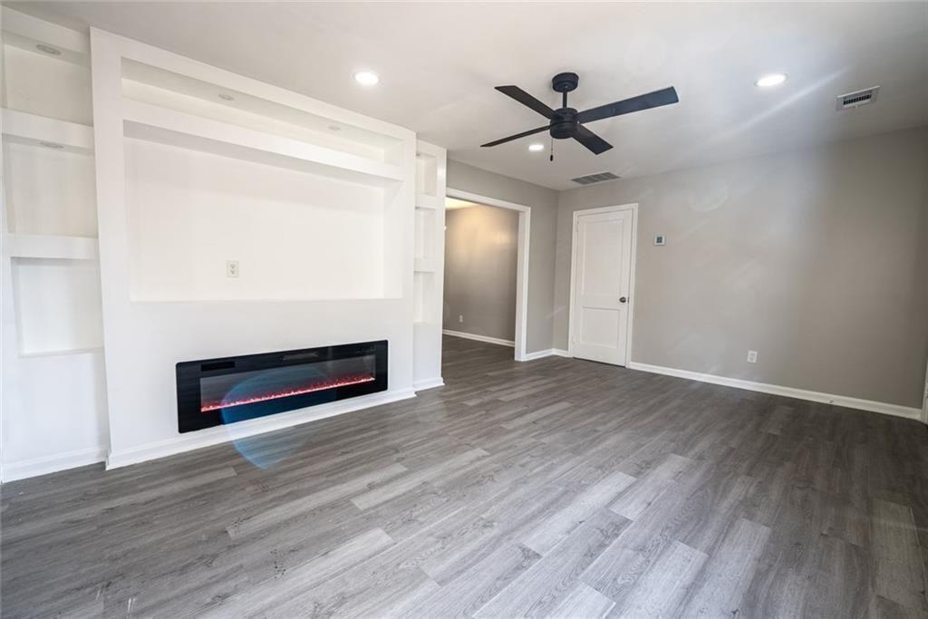 3122 Semmes Street Atlanta, GA 30344 - Photo 9 of 33 a view of an empty room with wooden floor fireplace and a window