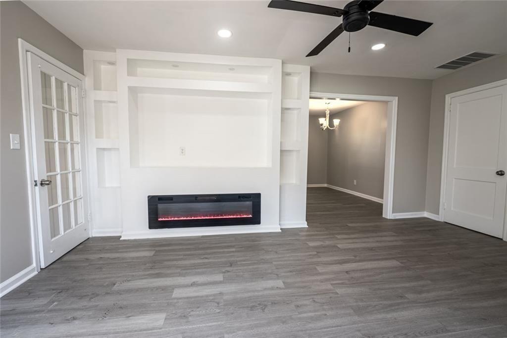 3122 Semmes Street Atlanta, GA 30344 - Photo 10 of 33 wooden floor in an empty room with a fireplace