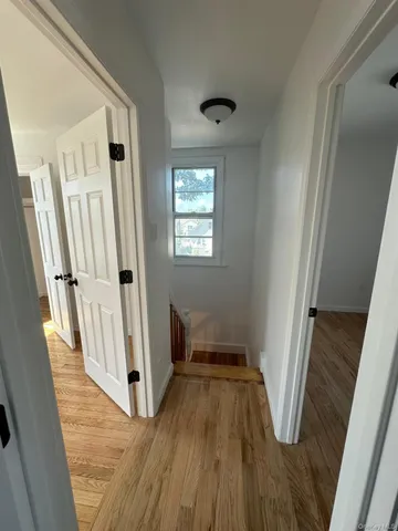 a view of an entryway with wooden floor