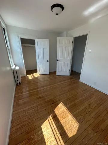 a view of a room with wooden floor