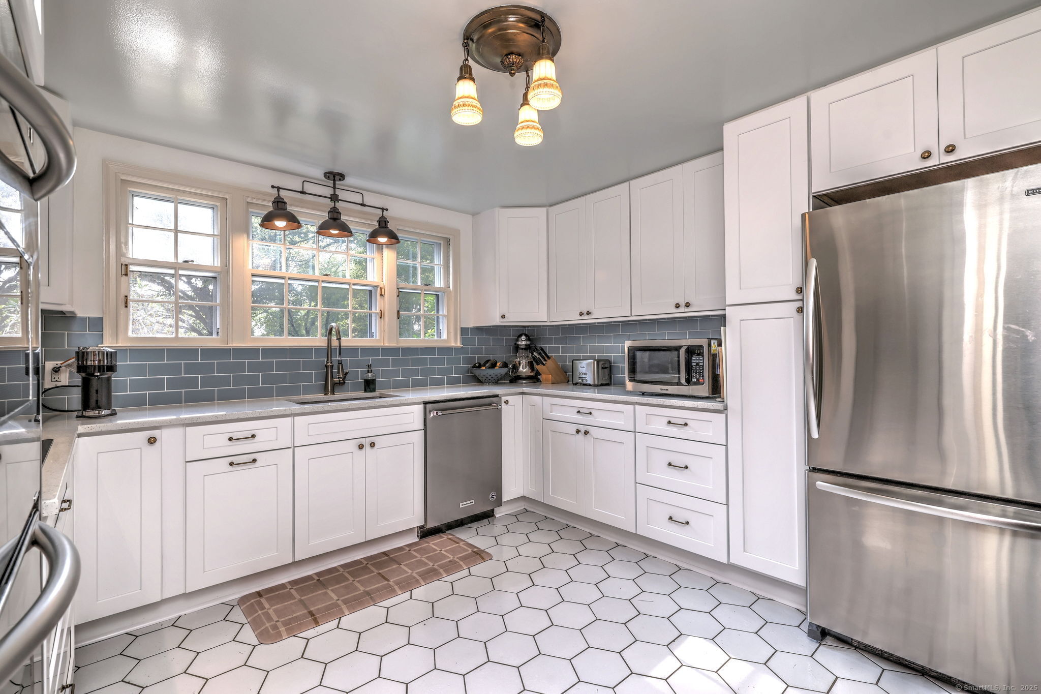 4 Brook Road Woodbridge, CT 06525 - Photo 17 of 40 a kitchen with granite countertop white cabinets stainless steel appliances and window