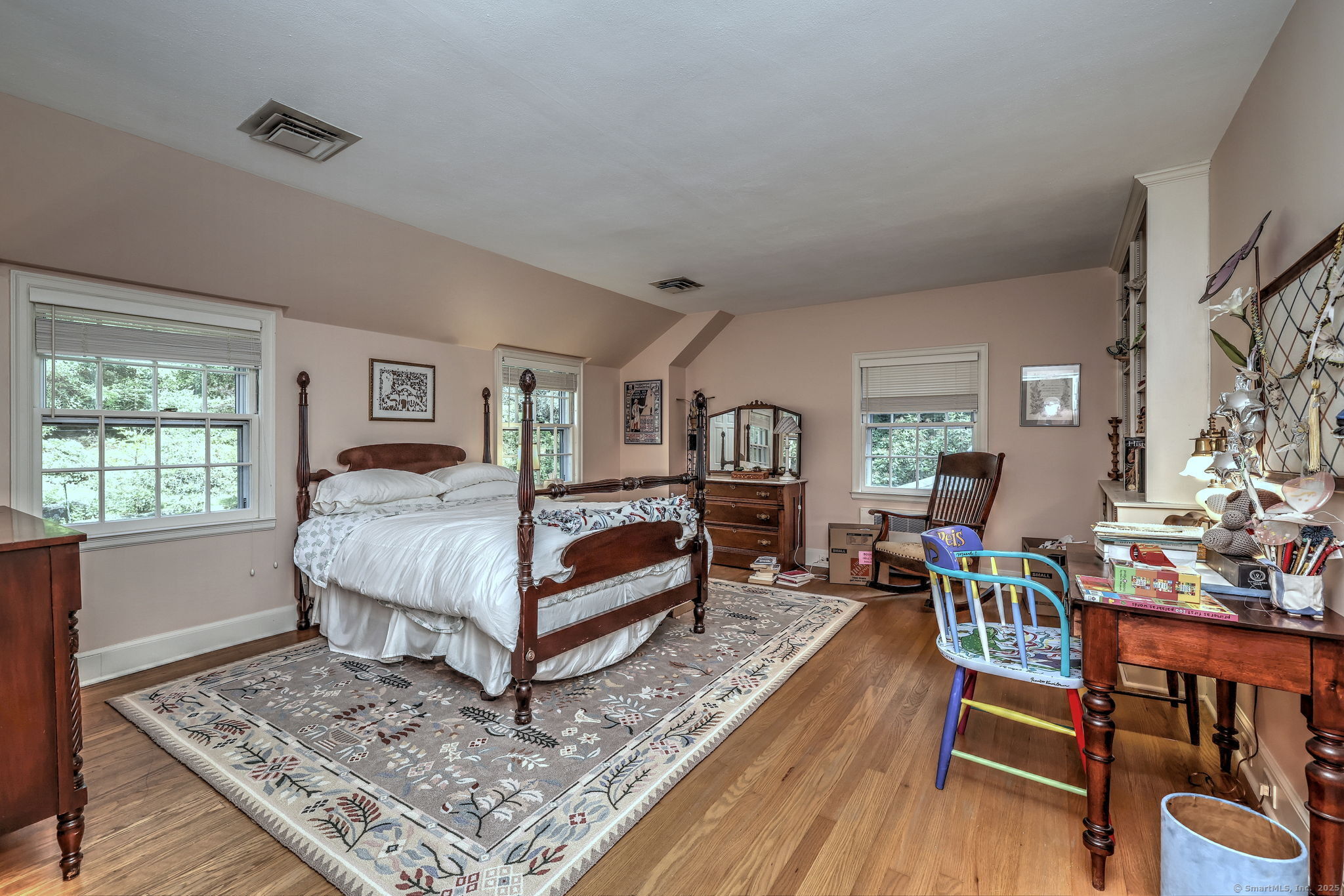 4 Brook Road Woodbridge, CT 06525 - Photo 30 of 40 a bedroom with a bed a table and with wooden floor