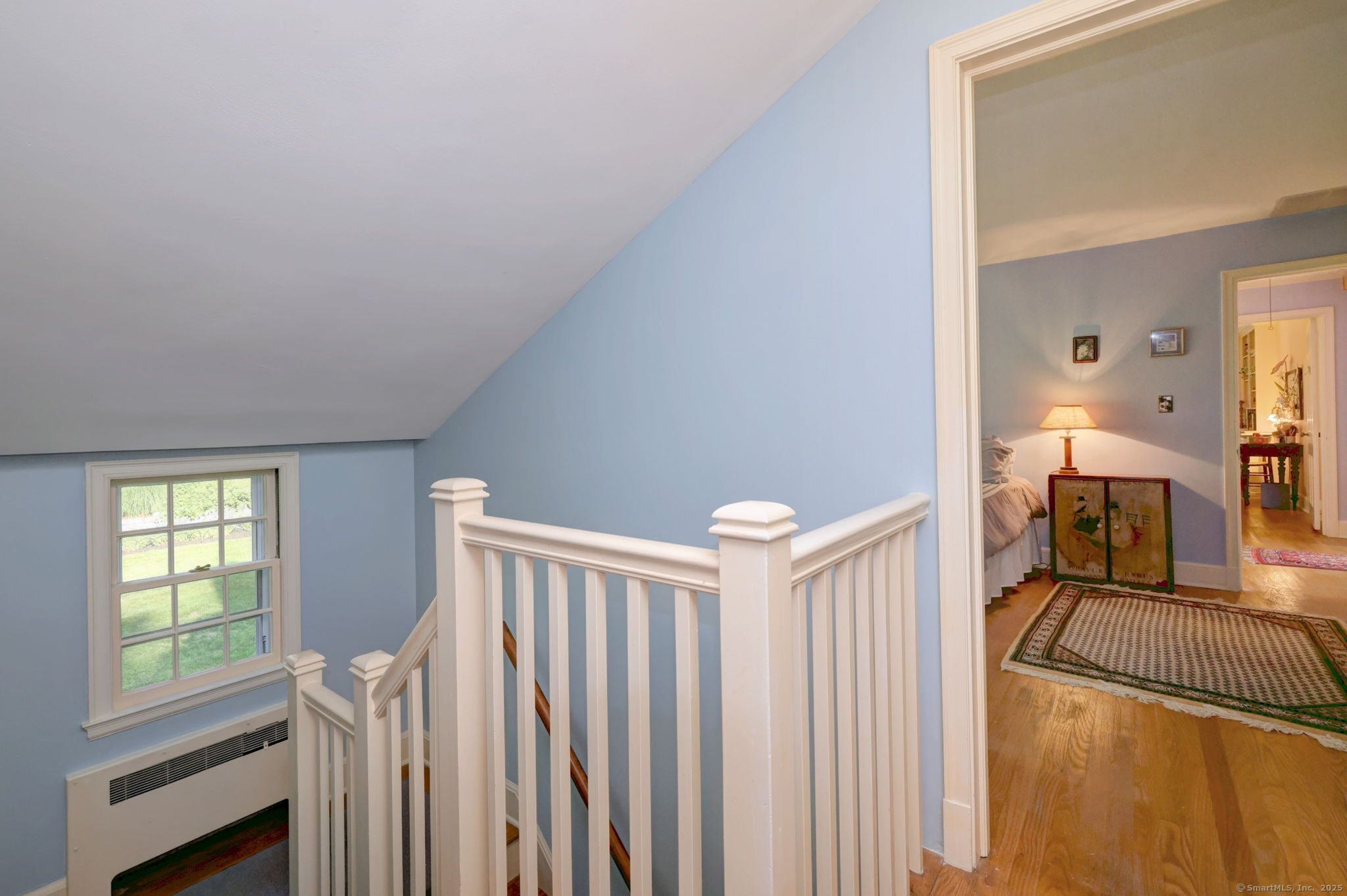 4 Brook Road Woodbridge, CT 06525 - Photo 35 of 40 a view of a livingroom with a dinning area wooden floor and staircase