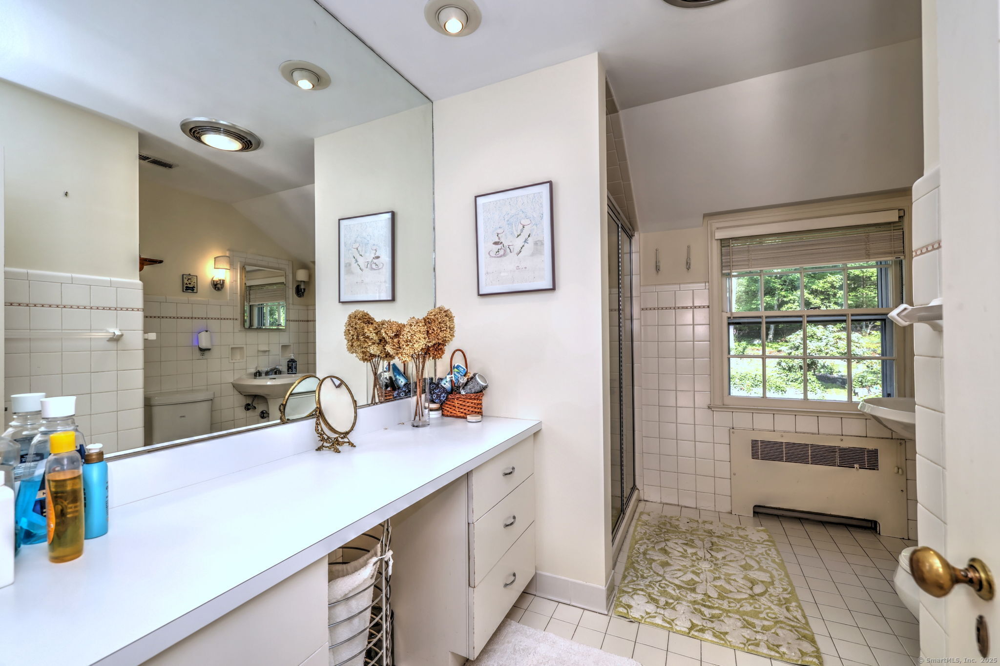 4 Brook Road Woodbridge, CT 06525 - Photo 36 of 40 a bathroom with a sink a mirror and a window