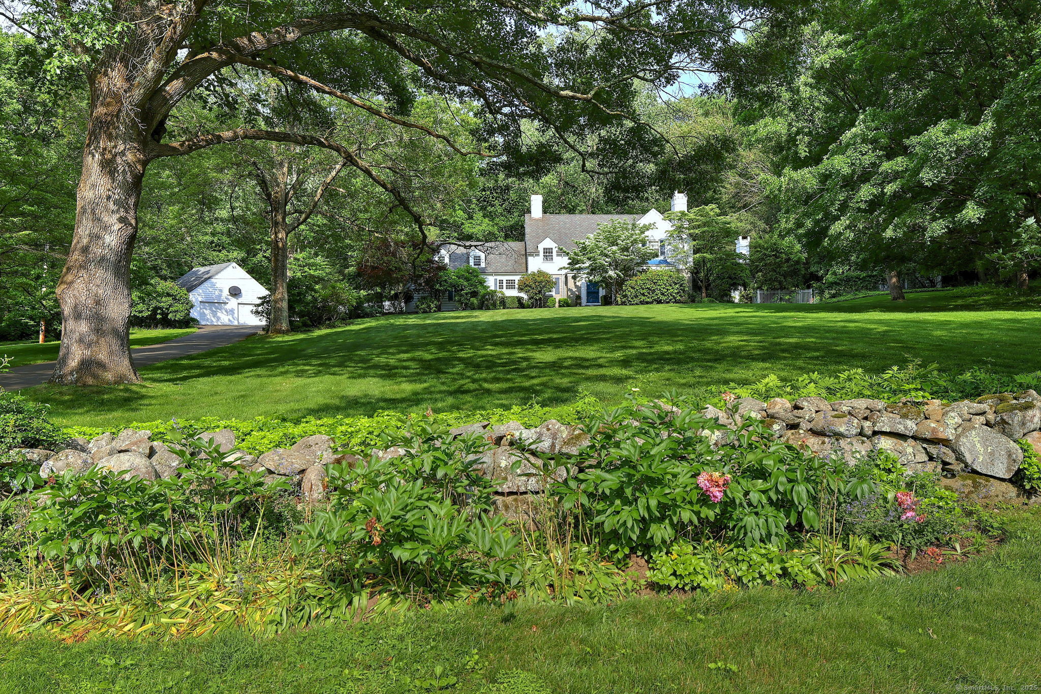 4 Brook Road Woodbridge, CT 06525 - Photo 38 of 40 a view of a house with a big yard and large trees