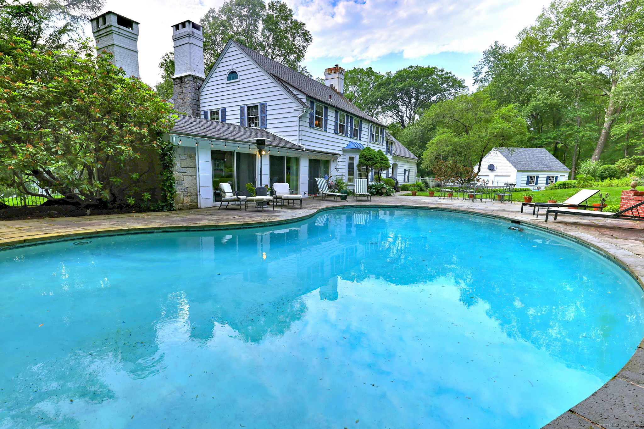 4 Brook Road Woodbridge, CT 06525 - Photo 7 of 40 a front view of house with swimming pool and green space