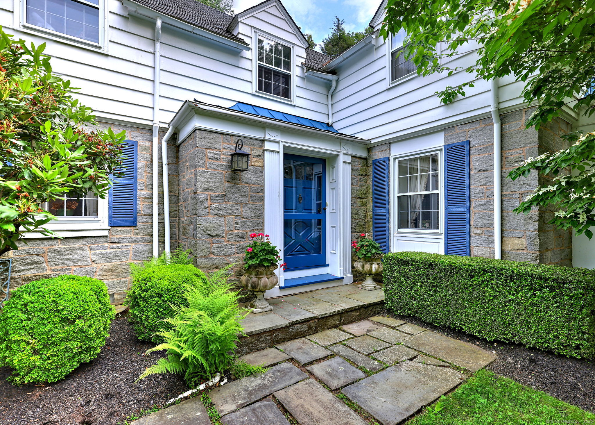 4 Brook Road Woodbridge, CT 06525 - Photo 8 of 40 a view of a house with brick walls plants and large tree