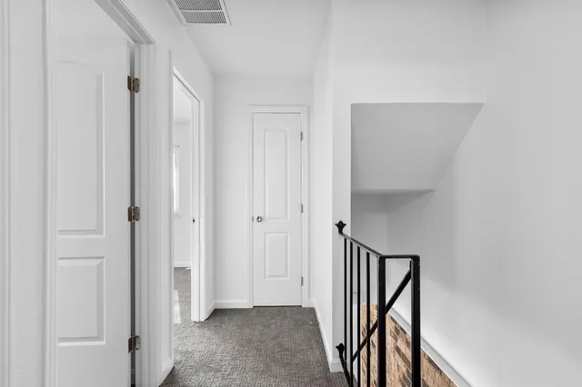 an empty room with closet and a chandelier fan