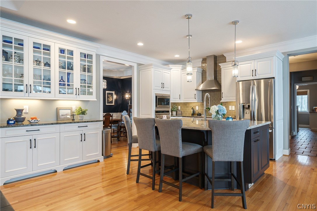 8262 Ashington Drive Lysander, NY 13027 - Photo 15 of 50 THE CHEF'S KITCHEN BOASTS A SPACIOUS ISLAND THAT S