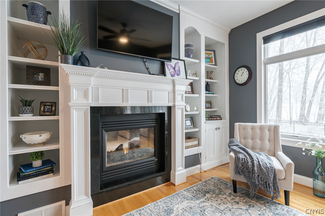 8262 Ashington Drive Lysander, NY 13027 - Photo 28 of 50 THE GAS FIREPLACE WITH CUSTOM MANTLE IS A BEAUTIFU