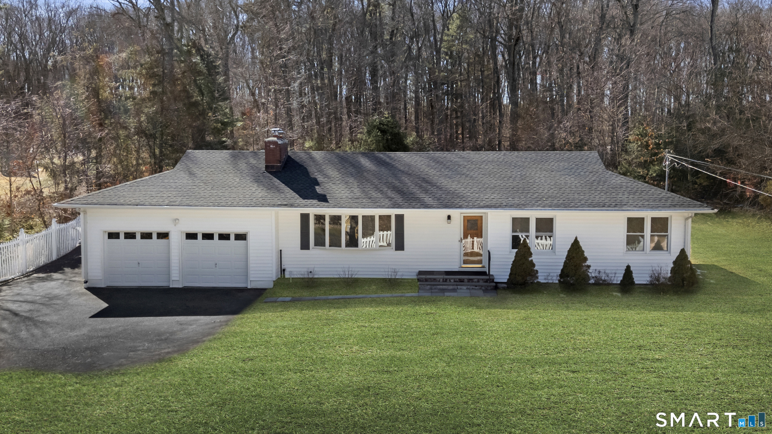 a view of a house with a yard and sitting area