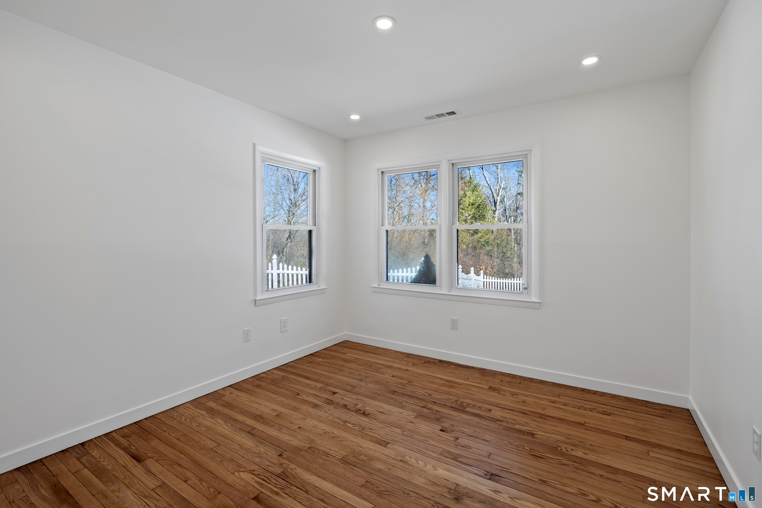 115 Wheeler Road Monroe, CT 06468 - Photo 11 of 18 a view of an empty room with wooden floor and a window