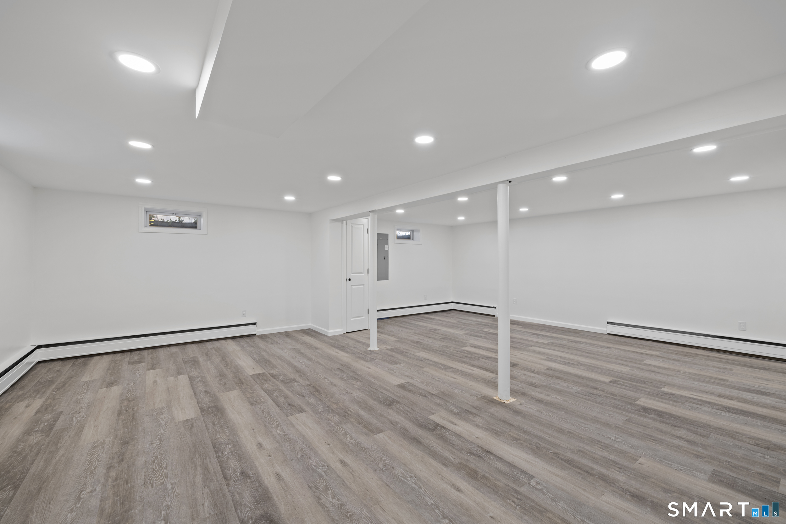 115 Wheeler Road Monroe, CT 06468 - Photo 13 of 18 a view of an empty room with wooden floor and a window