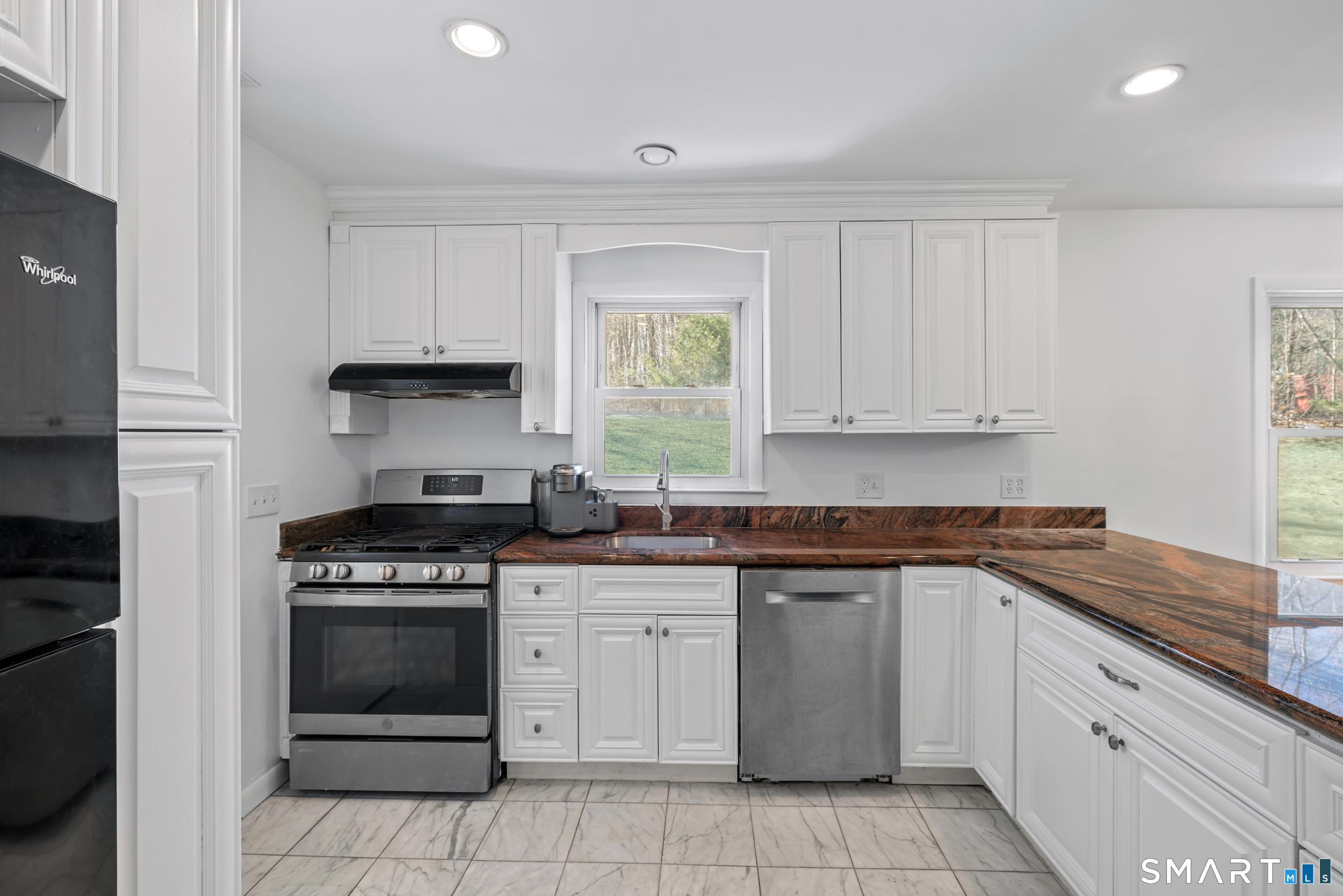115 Wheeler Road Monroe, CT 06468 - Photo 6 of 18 a kitchen with granite countertop white cabinets and appliances