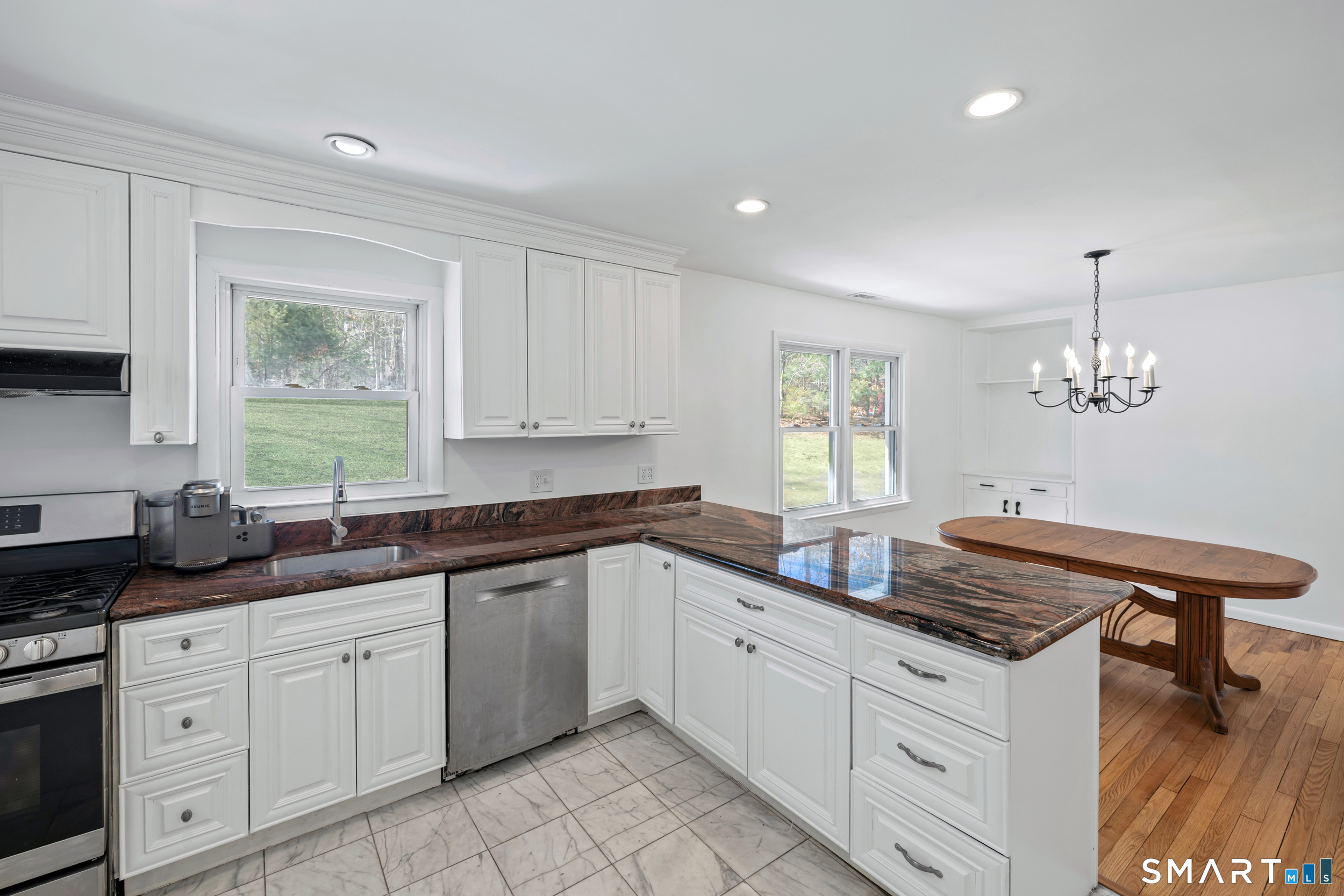 115 Wheeler Road Monroe, CT 06468 - Photo 7 of 18 a kitchen with granite countertop stainless steel appliances a sink stove and cabinets
