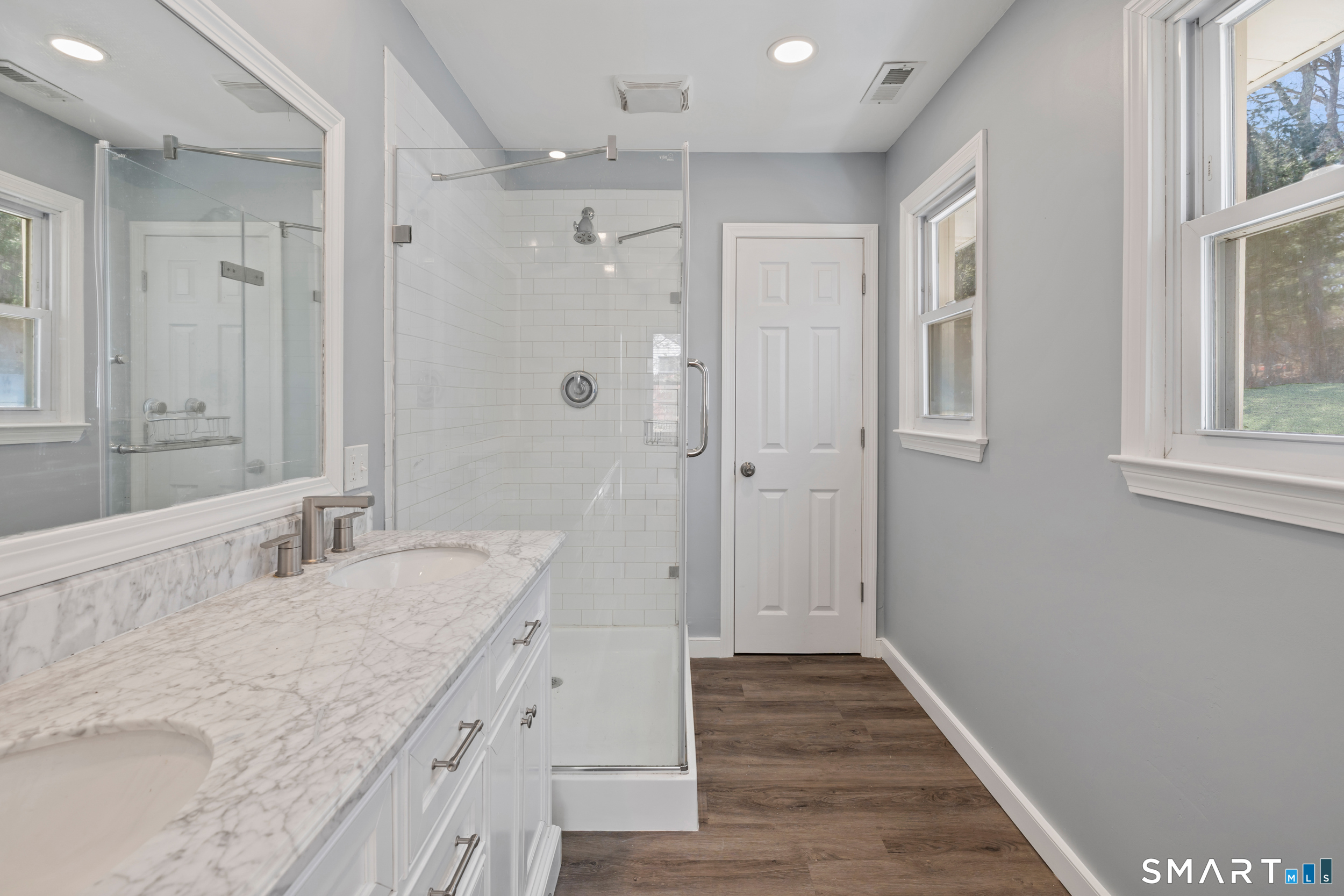 115 Wheeler Road Monroe, CT 06468 - Photo 9 of 18 a spacious bathroom with a granite countertop sink mirror and a shower