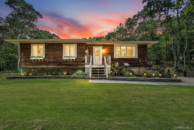 a front view of a house with a garden
