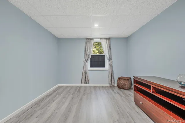 a view of room with wooden floor and window