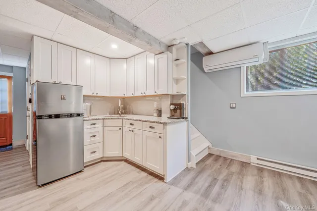 a kitchen with white cabinets white stainless steel appliances and sink