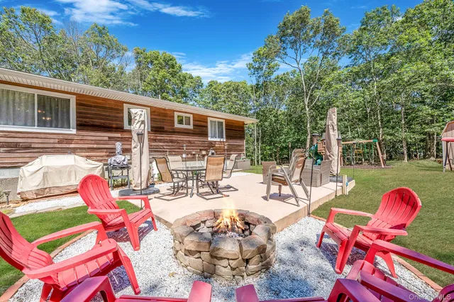 a view of a patio with a dining table and chairs with wooden floor