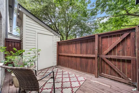 a view of backyard with cabin and wooden fencing