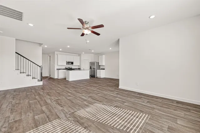 a view of a kitchen with a sink and wooden floor
