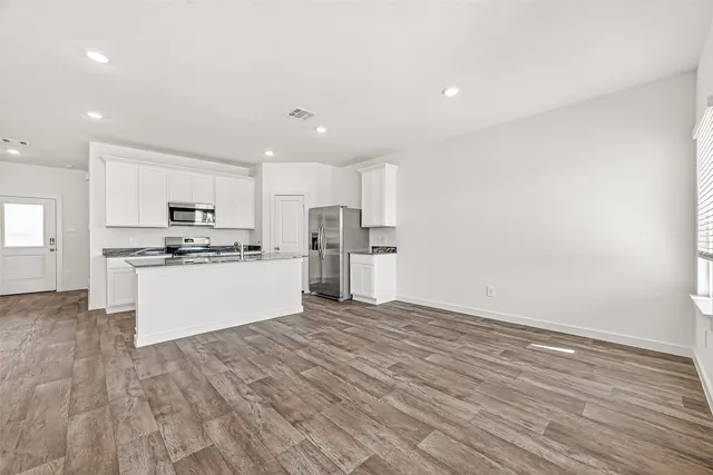 a view of kitchen with wooden floor