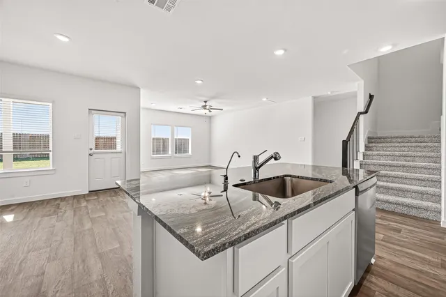a kitchen with a sink and cabinets