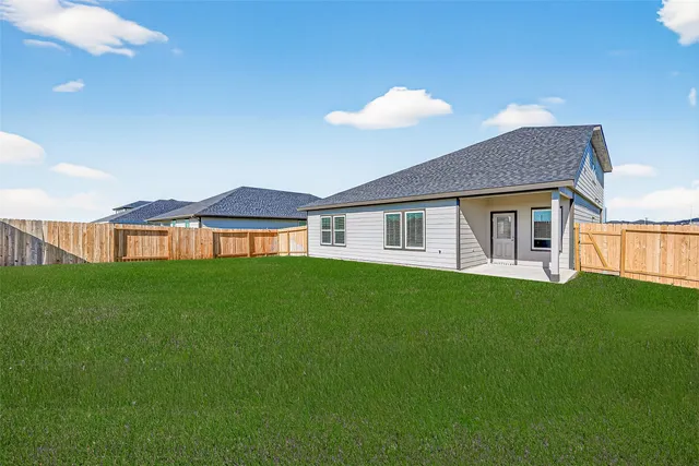 a view of a house with a backyard