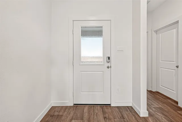 a view of front door with wooden floor