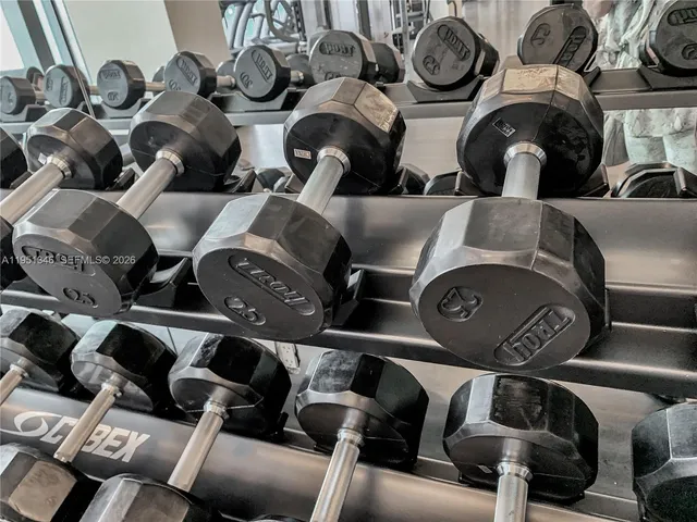 a bedroom with a large bed and a large mirror