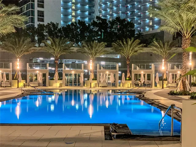 a bedroom with a large bed and a large window