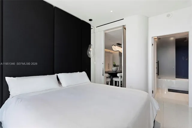 a bedroom with a bed and glass window