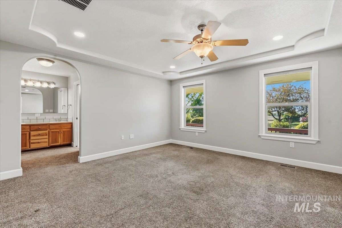 24240 Tiger Lane Caldwell, ID 83607 - Photo 19 of 50 Recessed ceiling with integrated lighting, ceiling fan, and carpeted flooring