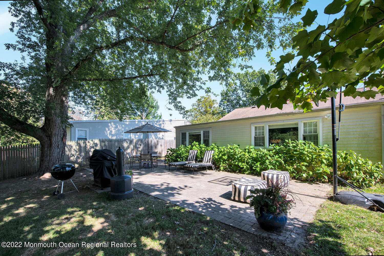 224 Garden Road Shrewsbury, NJ 07702 - Photo 26 of 33 a backyard of a house with yard and outdoor seating