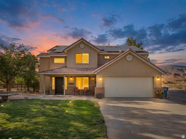 1440 West 100 South Virgin, UT 84779 - Photo 1 of 45 Two-story residence featuring a terracotta-style roof, stucco exterior, and an attached two-car garage